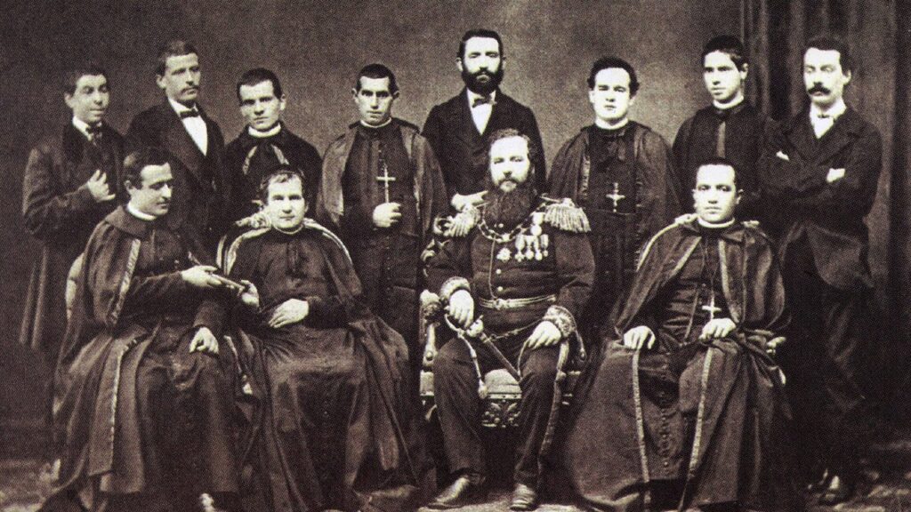 Dom Bosco entrega as regras salesianas a João Cagliero, chefe da primeira expedição missionária