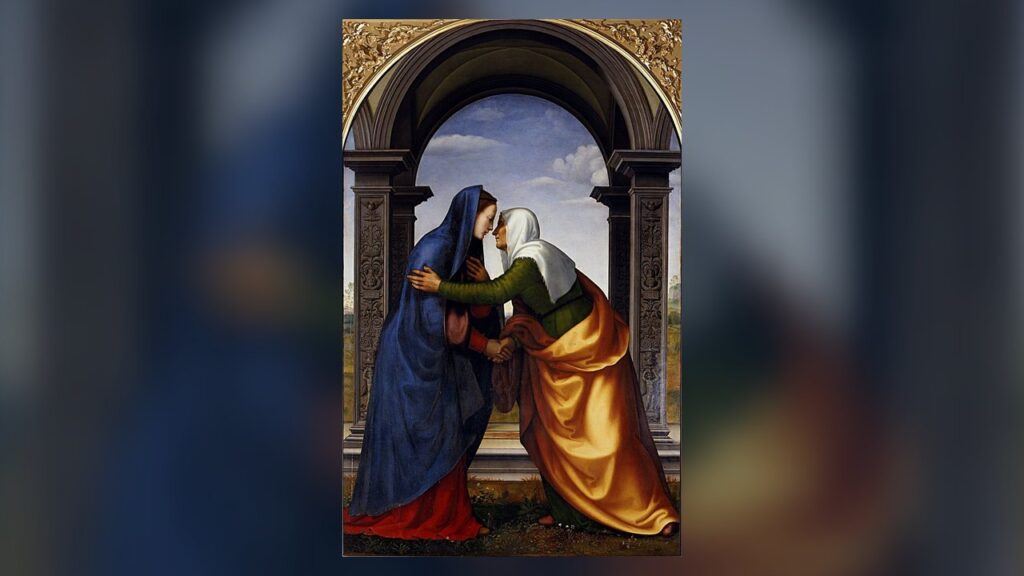 Maria e Isabel se abraçam sob um arco, como narra Lucas 1,39-45