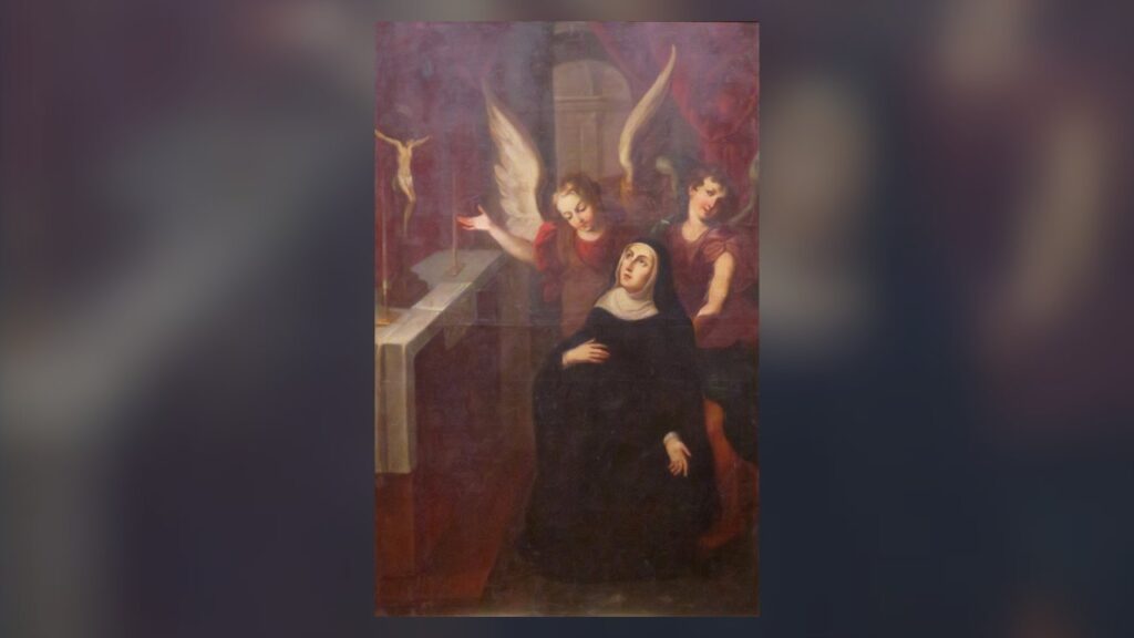 Santa Rita de Cássia em oração diante do crucifixo, santa das novenas de petição